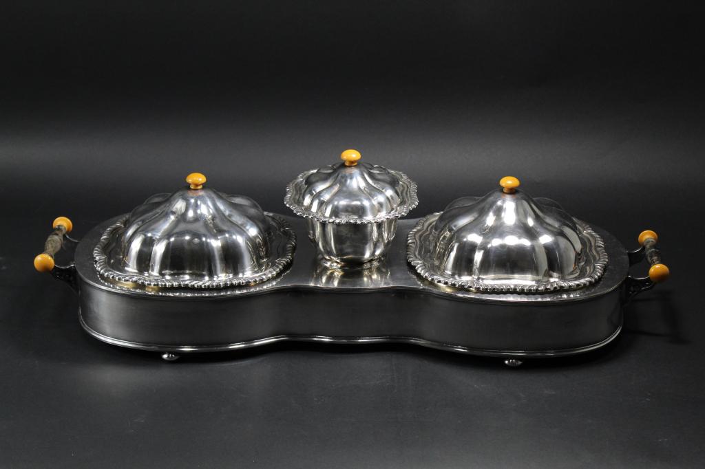 Warwick Silver Plate Entree Chafing Dish Set: Triple serving dish chafing dish set with base. Appears to be butterscotch bakelite and ebony handles. Base stamped WARWICK HSM EPC 22716. Very good condition with mellow silver patina; no significant