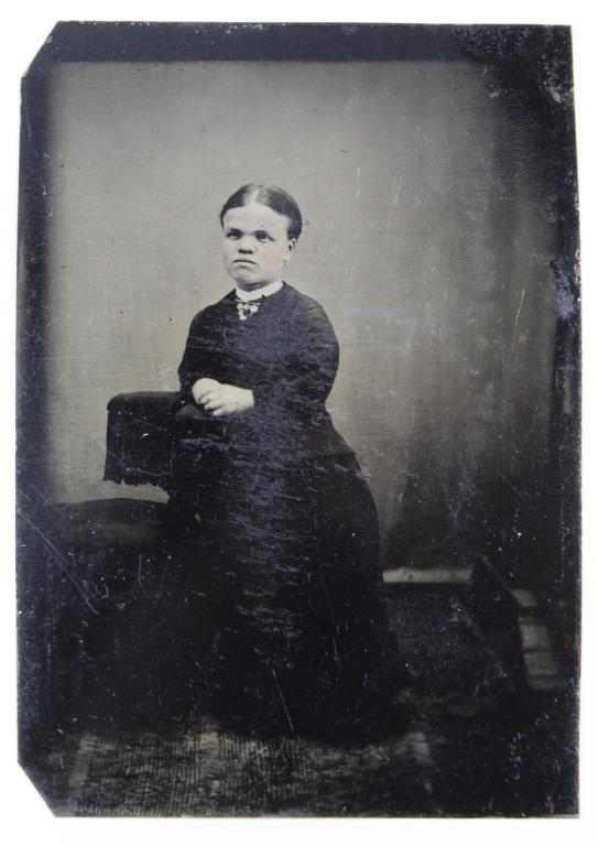 Antique Tintype Photgraph Dwarf / Little Person: Woman in a formal black dress posed in a studio. Good clear image with normal age and wear, etc. 3 1/2" x 2 1/2" approx.