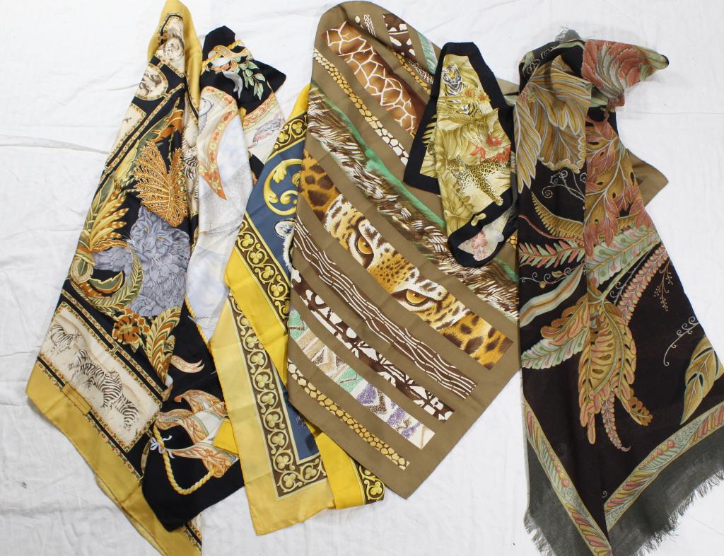 Scarves by Salvatore Ferragamo: Six silk scarves, 5 with rolled and sewn hems: one, a black borderd multicolor 34" sq.; one has big game within a gold border 33" x 34"; big cats bordered in black 16.5 sq.; a tiger within a gold bord