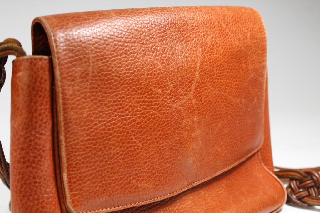 Vintage Desmo Leather Crossbody Bag: The Desmo red leather hag has a braided brown leather handle with 20" drop. An embossed badge inside reads "Desmo: Made in Italy for Nieman Marcus. Condition good, with some corner wear to bottom, sof