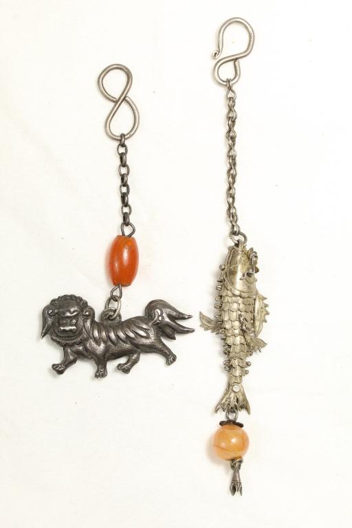 Chinese Tibetan Articulated Fish & Kirin Amulets: (1) Well detailed articulated fish pendant with lotus on head. Mounted on chain with hook and glass bead. No apparent marks; possibly sterling. Fish 2 1/4" approx. Total length 6 1/4" approx. (2) Silv