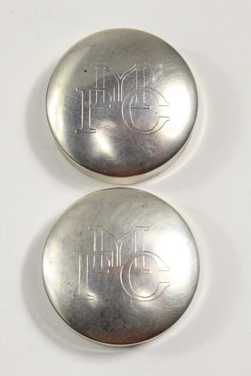 Pair Vintage Sterling 925 Pill Boxes: Matched sterling pill boxes with engraved capital letters. Stamped 925 VOURAKIS along with hallmark. Very good condition. 46 total grams approx. 5/8" H x 1 3/4" dia.