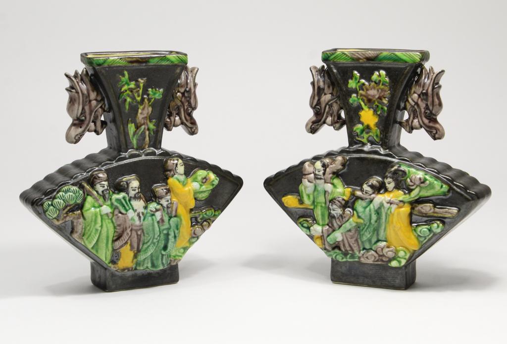 Pair Chinese Porcelain Fan Shaped Vases: Matched pair black glaze vases with high relief figures of the 8 immortals in tri-color glaze to each side. Dragon head / pearl of wisdom handles. Underglaze character marks. Excellent condition with 