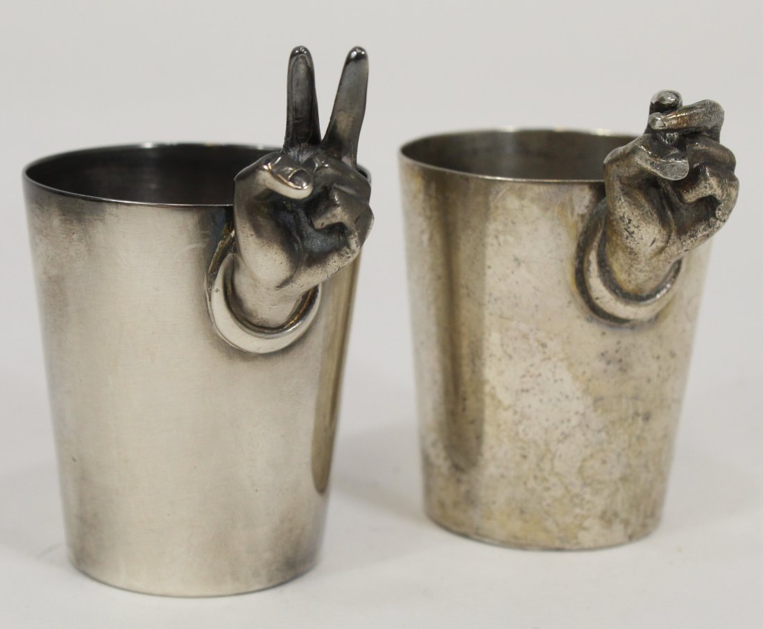 Napier 2 Finger Silver Plate Jiggers: Cast hand with two raised fingers. Impressed 1 and 2 measure marks to side. Stamped NAPIER to bottom. Very good condition with aged patina; tiny dent to side. 3" H. Lot includes additional 2 finger ji