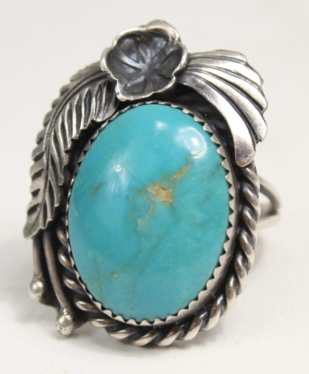 Robert Kelly Navajo Turquoise & Sterling Ring: Polished center turquoise stone with natural inclusions (7/8" x 5/8" approx). Stamped ROBT. KELLY. Size 7.5 approx. 10 grams total weight approx.