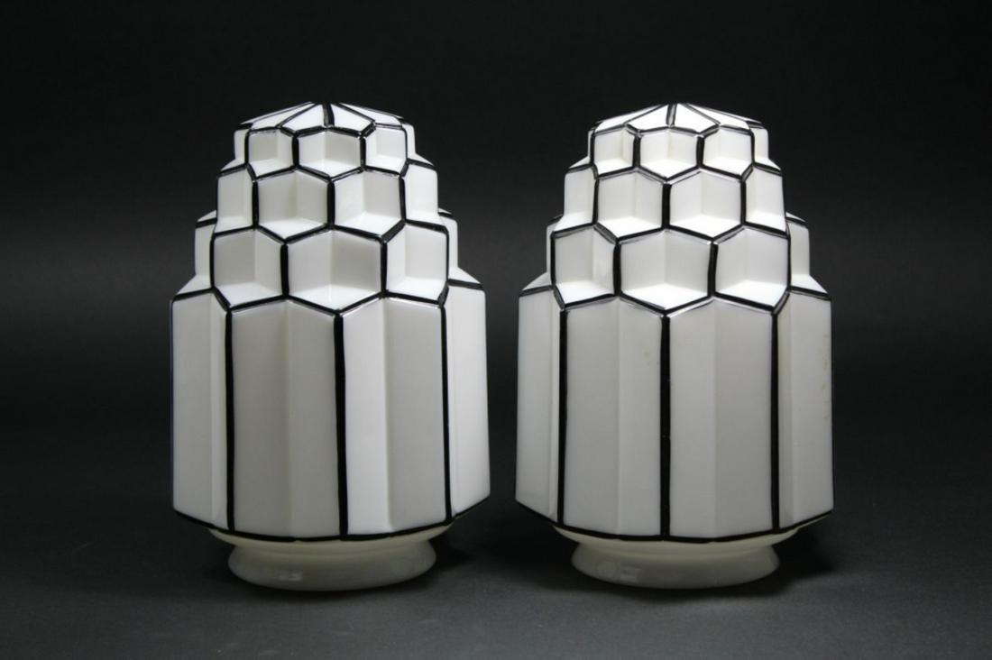 Pair Vintage Art Deco Skyscraper Light Globes: Pair faceted art deco skyscraper light globes in milk glass with black accent lines. Excellent condition. 9" H x 6" dia. approx. Top of openings 3 7/8" approx.