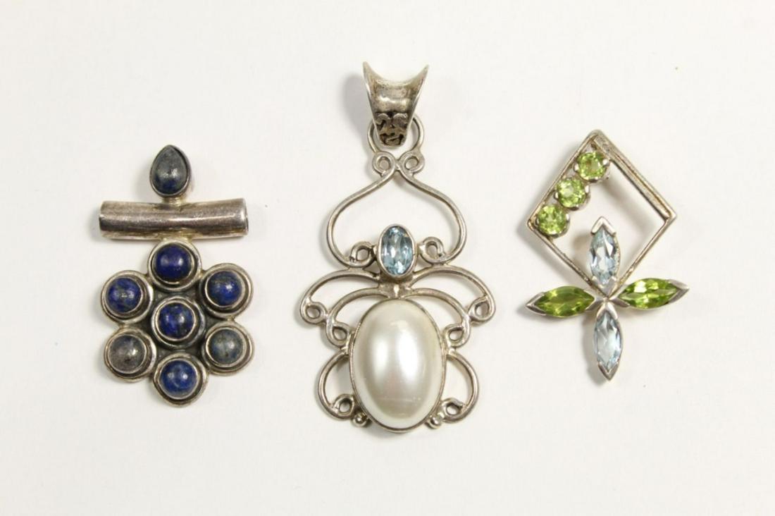 Sterling and Gemstone Pendants: (1) Pendant with faux pearl and blue facet cut gemstone. 2" (including bail) x 1 1/8" approx. (2) Pendant with 7 blue and green facet cut gemstones. 1 1/2" x 7/8" approx. (3) Pendant with 8 lapis type