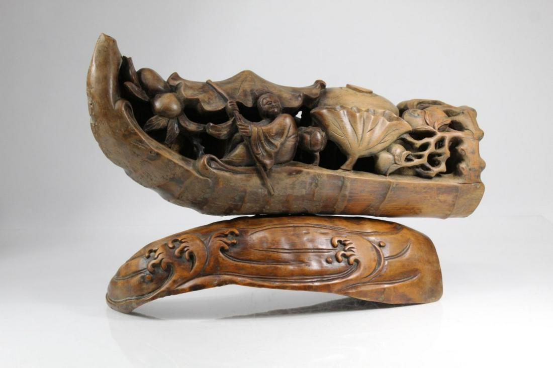 Chinese Large Carved Bamboo Lotus Boat 19.5" L: Chinese large Carved Bamboo Lotus Boat with a woman paddling the laden boat, the base water with waves, wear to finish , one small crack to rear, 19.5" LX 13" high