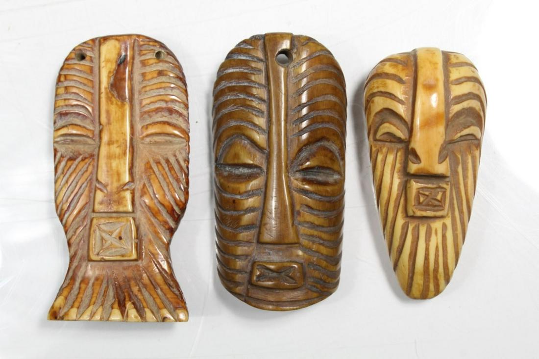 3 African Songye Bone Passport Masks Pendants: 3 African Carved Bone Passport Masks Pendants from the Songye tribe in form of kifwebe masks, all are in good condition , Largest mask 3.25" long