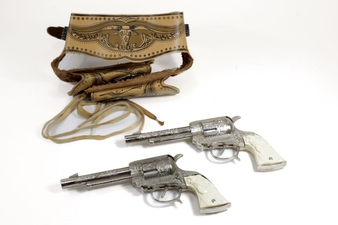 Vintage Wild Bill Hickock Cap Gun Holster Set: Vintage Wild Bill Hickock Cap Gun Holster Set. Double cap guns with ivory colored handles. Good condition, working action, untested with caps, measures approx. 9.5" long. Belt and holster are in good
