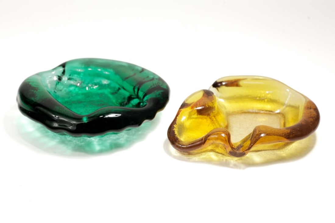 Pair Blenko Vintage Freeform Glass Bowls: Pair Blenko Vintage Freeform Bowls, 1958-61. Green bowl is signed with sandblasted logo on base. Green bowl measures approx 1.75x7" and orange bowl measures 1.5x8x6". Some light scattered scrtches, ov