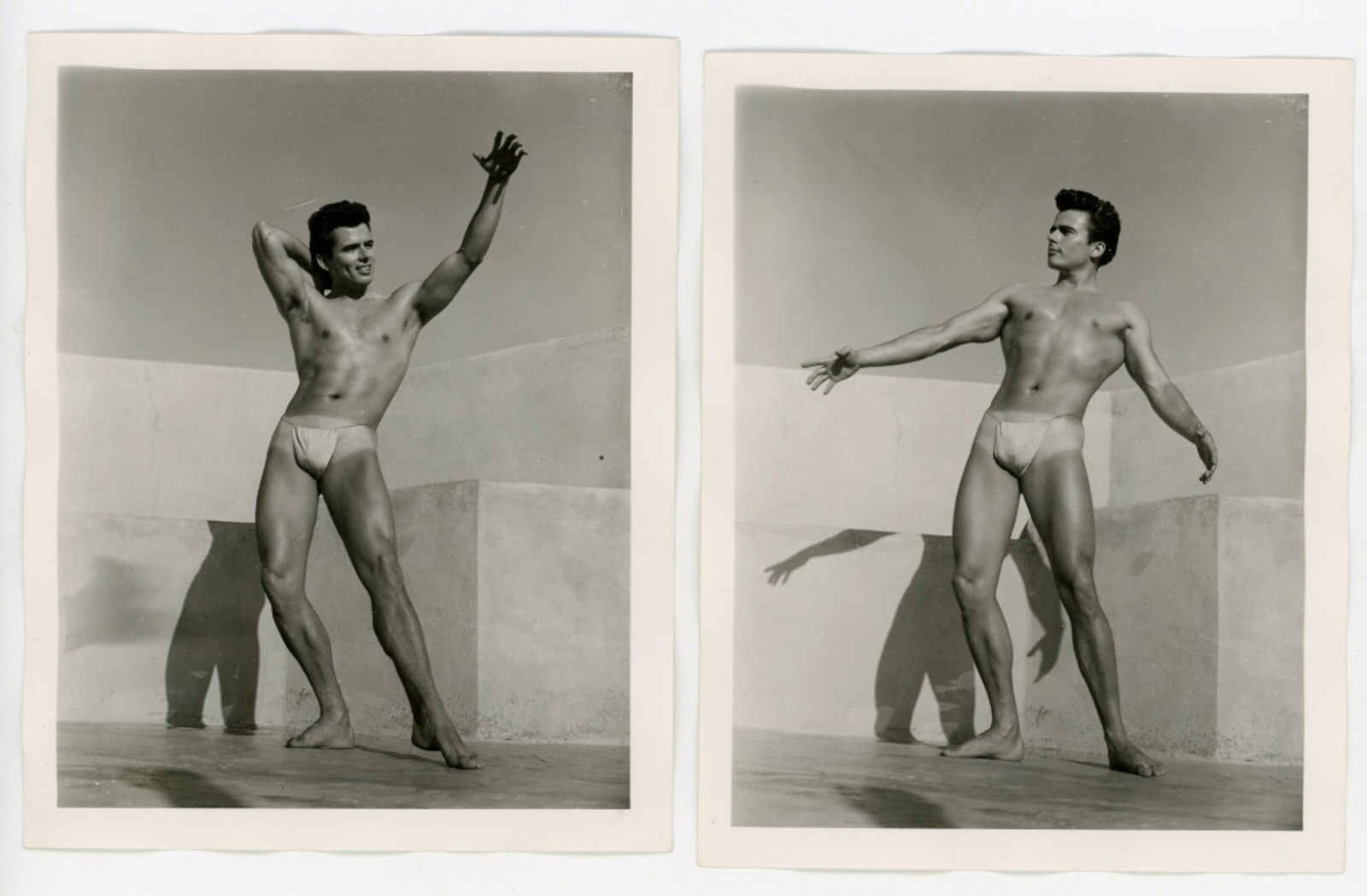 Vintage Bob Mizer AMG Male Physique Photographs: Two semigloss 4" x 5" photographs of male model wearing posing strap on the AMG studio rooftop. Pencil numbered 4 and 6 to the backs; one dated July 1956. Good condition. From the estate of model pict