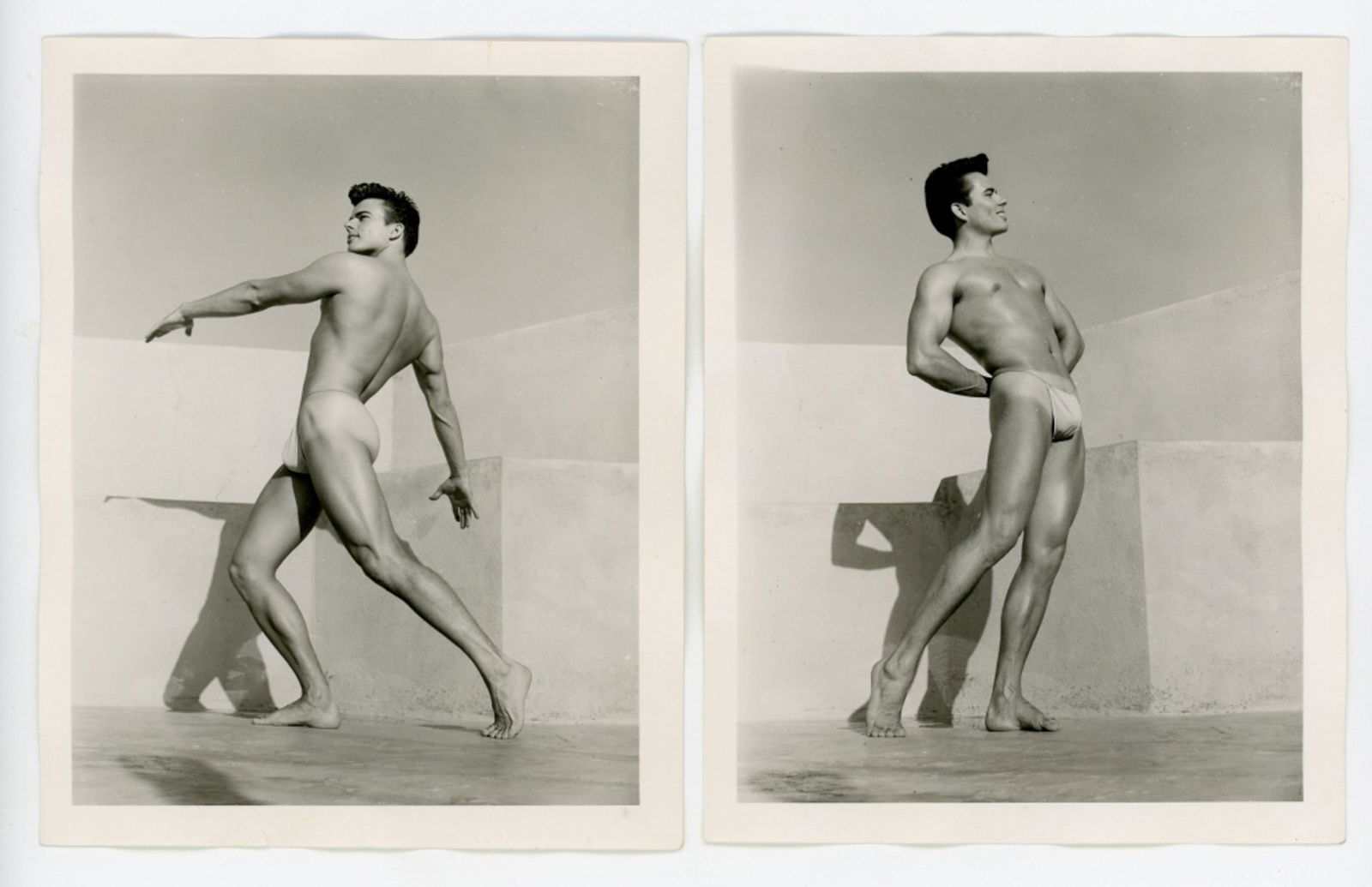 Vintage Bob Mizer AMG Male Physique Photographs: Two semigloss 4" x 5" photographs of male model wearing posing strap on the AMG studio rooftop. Pencil numbered 3 and 7 XGII-H to the backs; one dated July 1956. Good condition. From the estate of mod