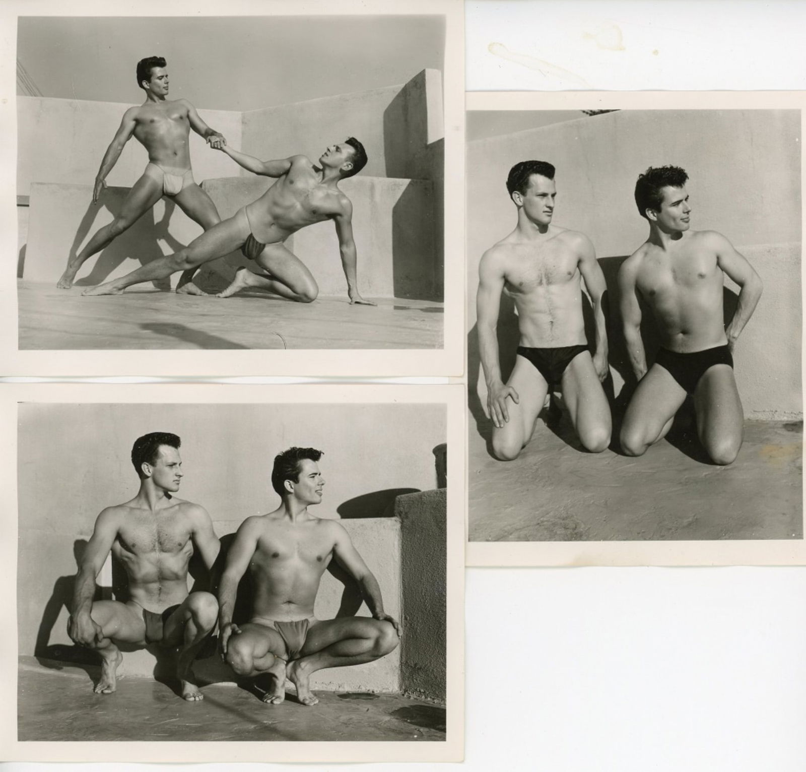 Vintage Bob Mizer AMG Male Physique Photographs: Three semigloss 4" x 5" photographs of two male models wearing posing straps on the AMG studio rooftop. One pencil numbered 35, one numbered 4 and stamped 045R, and one stamped 005R to the backs. Good