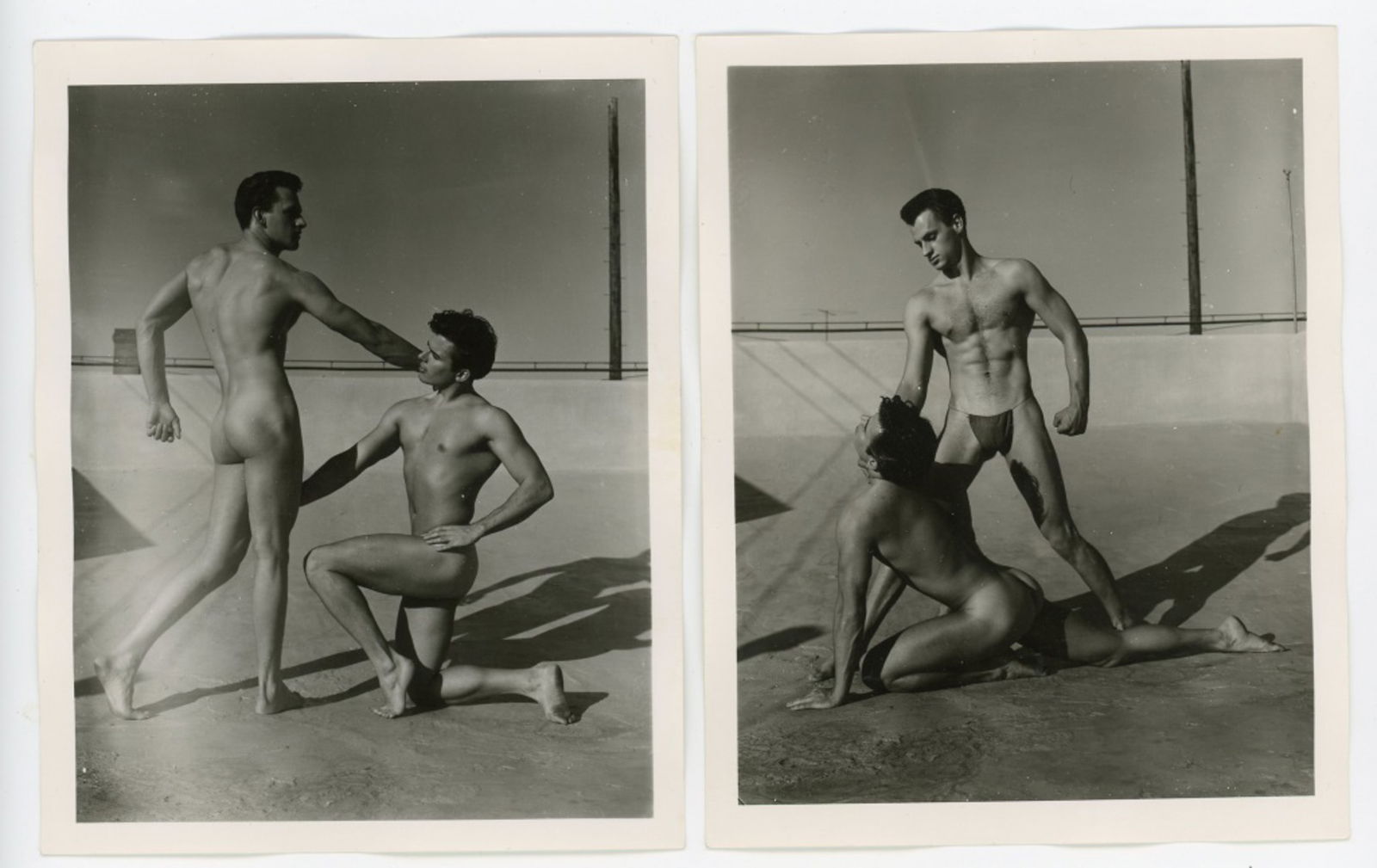 Vintage Bob Mizer AMG Male Physique Photographs: Two semigloss 4" x 5" photographs of two male models posed on the AMG studio rooftop. Stamped 004R and 010R to the backs. Good condition. From the estate of model pictured.