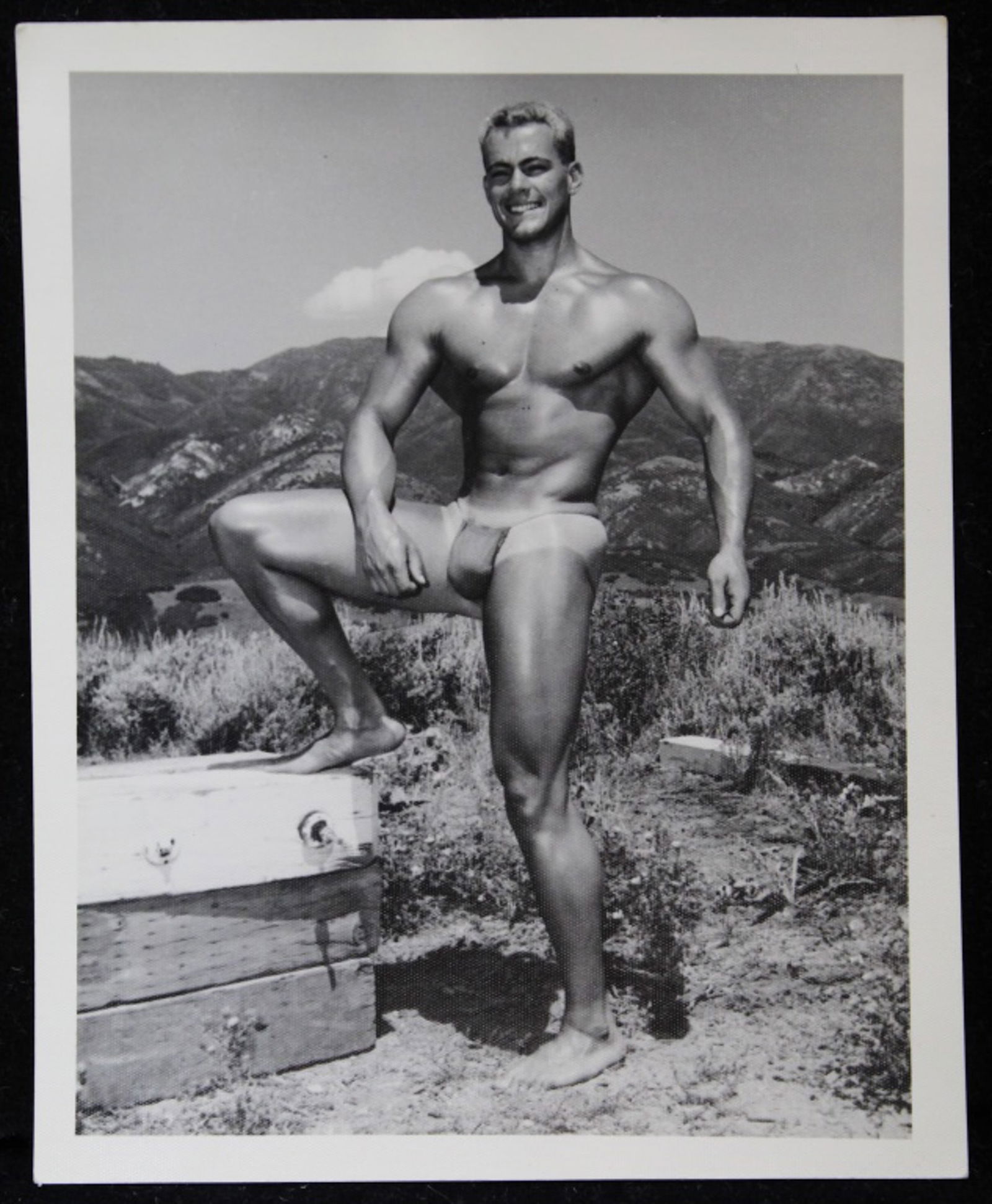 Bruce of Los Angeles Male Physique Photograph: Vintage original 4" x 5" Bruce Bellas / Bruce of Los Angeles photograph of model Mike Sill posed outdoors. Stamped "Bruce 77-1". Clear sharp image on double weight textured paper.