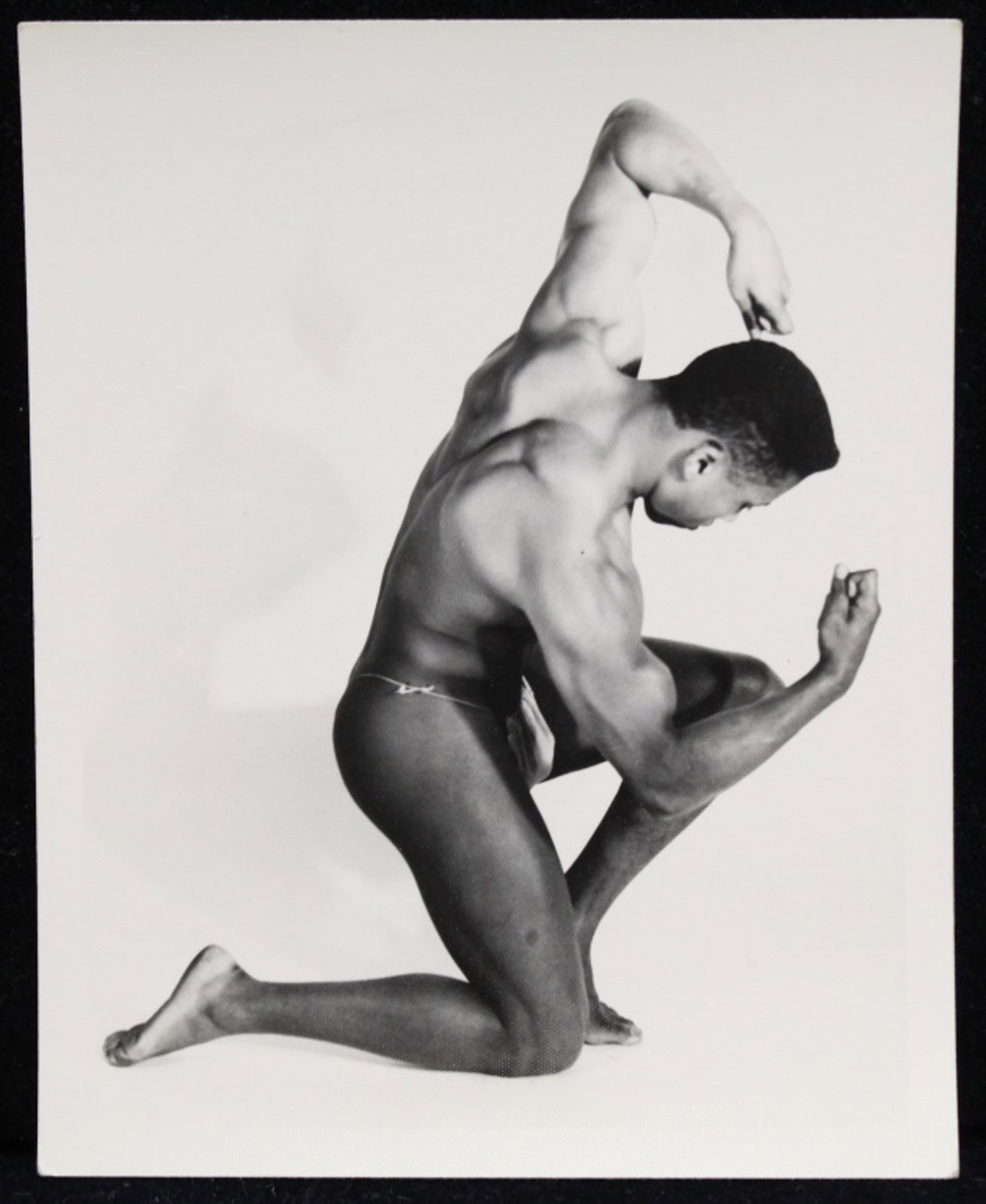Kris Studio Male Physique Photograph: Vintage original 4" x 5" Chuck Renslow / Kris Studio photograph of model in bodybuilding pose. KRIS STUDIO stamp and pen written 6. Clear sharp image on double weight textured paper.