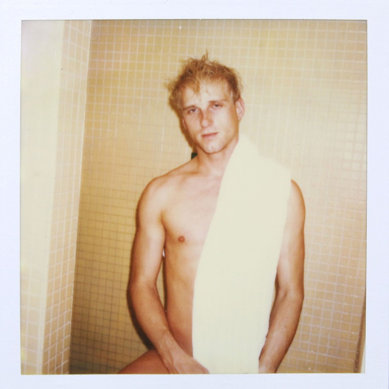 1980's Polaroid Photograph of Actor Leo Ford: Original Polaroid photograph of 1980's porn actor Leo Ford posed in tiled room with towel over shoulder. Good condition. 4.25" x 3.5".