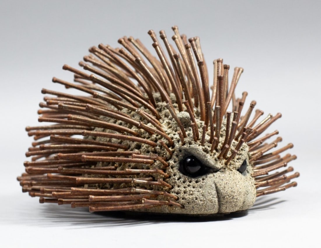 Lou Rankin (1929-2016) Porcupine Sculpture: Porcupine sculpture in cast concrete, various sized nails, and inset black glass eyes. Marked to bottom with 1994 date. Appears in excellent condition. 5.5" H x 8.5" x 8" approx. Rankin's biography at