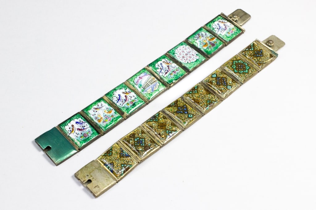 Two Antique Panel Link Bracelets: Both are of silver metal, with identical style clasps, 8 panel links, and stamped mark, perhaps Sanskrit. One has enameled handpainted pictures on each link with green background. The other has intric