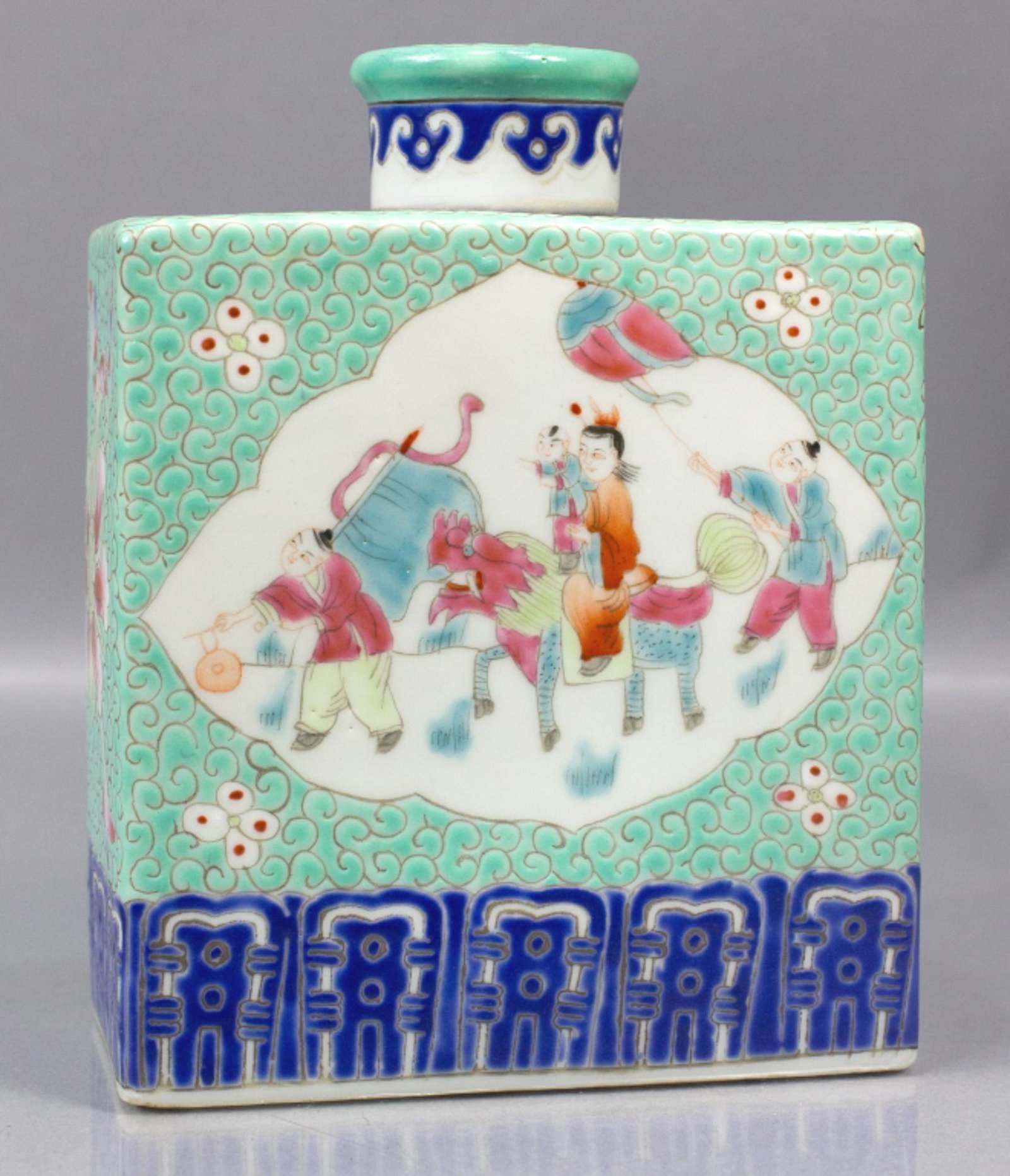 Chinese Famille Rose Porcelain Tea Caddy: Chinese Famille Rose porcelain tea caddy with hand decorated figural panels to each side. Turquoise ground with lotus bloom to each side end. Unmarked. Excellent condition. 6" H x 4.75" x 2.75".