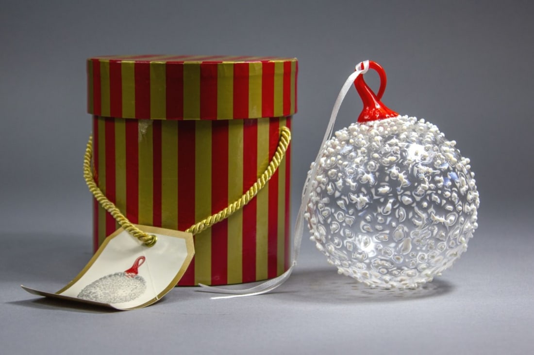 David Levi 1995 Nordstrom Art Glass Ornament Pilchuck Artist: Hand blown snowball style Christmas ornament in clear glass with raised white glass pieces and reddish stem. Etched IBEX signature and 1995 date to stem. Excellent condition. 4" dia. approx. Original