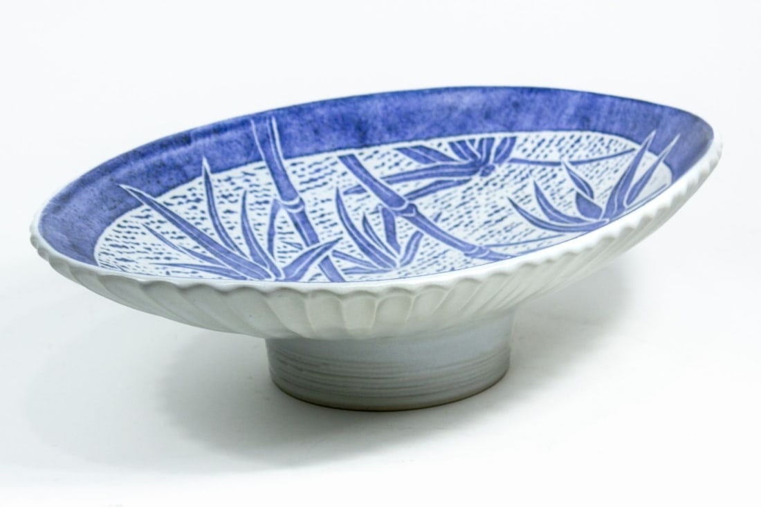 Large Asian Porcelain Blue and White Footed Bowl: Large Asian porcelain blue and white footed bowl. Contemporary. With underglaze blue bamboo and wave design painted inside. Outside deeply scalloped. Marked on bottom. In very good condition. Measures