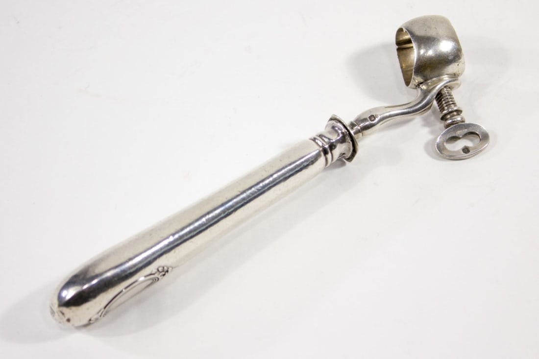 Antique French Silver Shank Bone Holder: 19th century French silver ham bone / lamb shank holder. Handle with blank cartouche to one side. Stamped with three Minerva head marks and two Bigorne anvil insect marks along with HF (?) initial sta