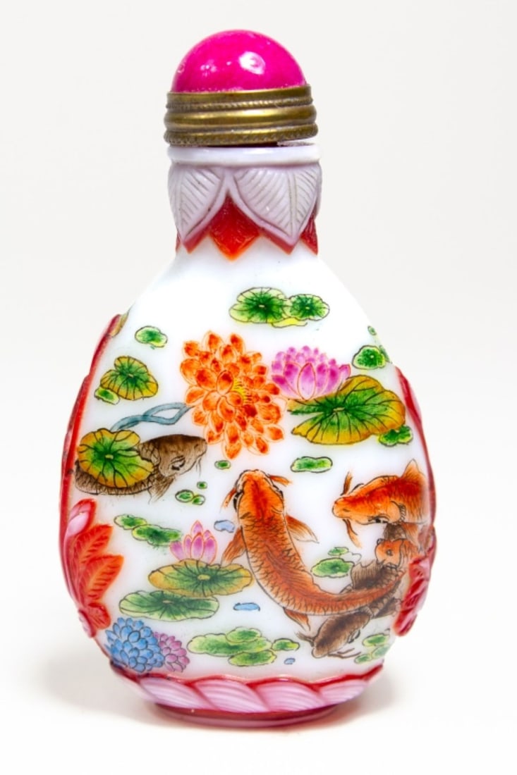 Chinese Enameled Glass Fish & Bird Snuff Bottle: Chinese enameled glass snuff bottle. With painted carp among lotus, peony, and lillypads. Applied glass bird and flowers in red and pale glass. Red stone stopper with metal spoon intact. Four characte