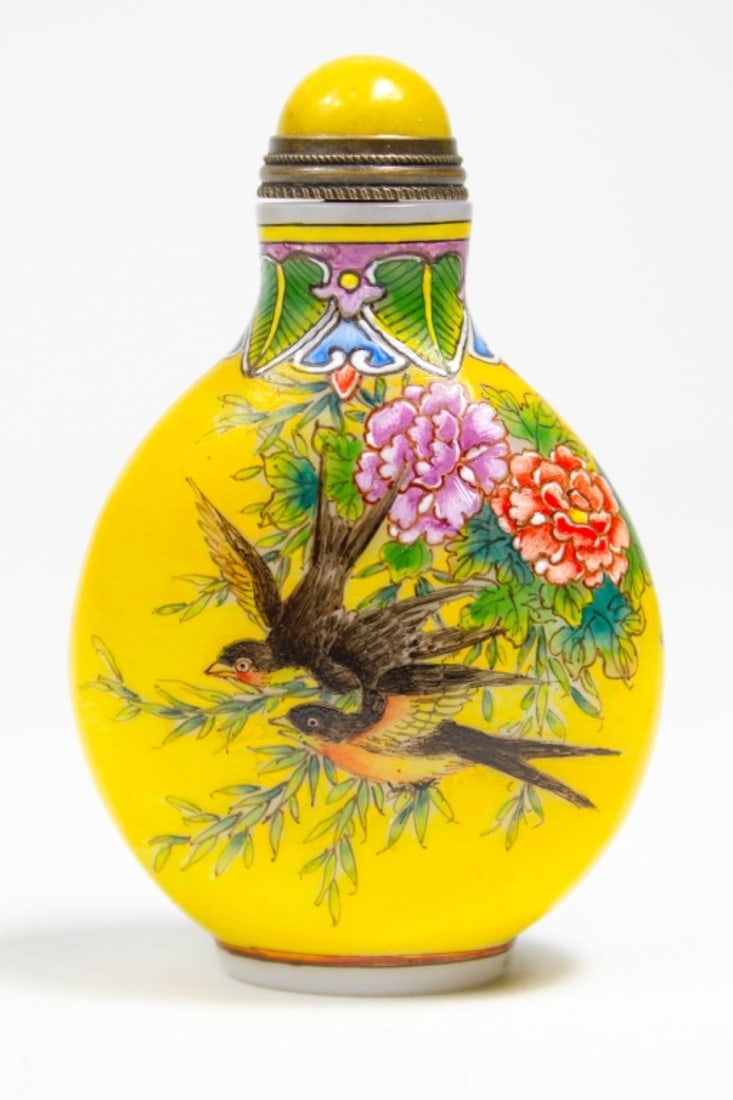 Chinese Enameled Glass Yellow Ground Snuff Bottle: Chinese yellow ground enamelled snuff bottle. With birds in flight over multicolored peonies and leaves. Yellow stone stopper with metal spoon intact. Four character Qianlong mark on blue enamel on ba