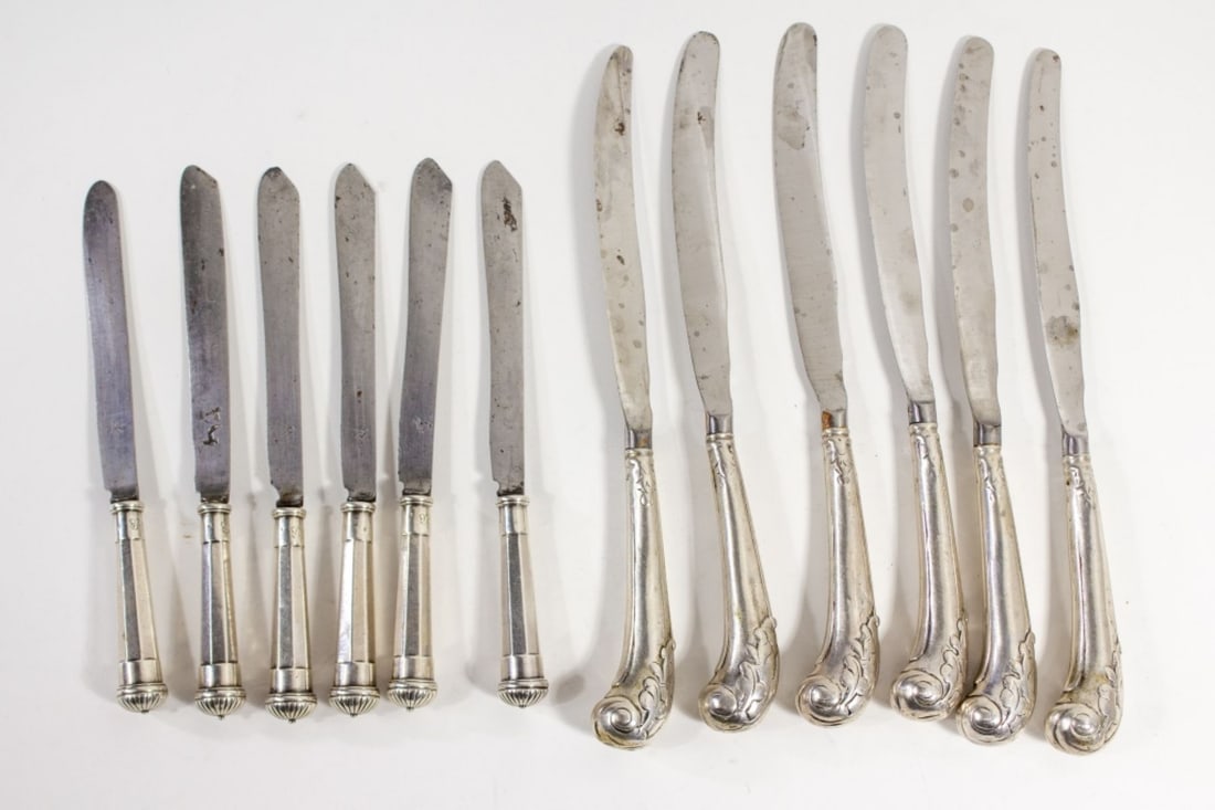 18th C. Steel Blade Knifes w/ Sterling Handles: Two sets of 18th century table knives. (1) Set 6 steel blade dinner knives with silver pistol handles. Handles with small pictorial hallmarks (possibly a scorpion?) and Q stamps. Blades unmarked. 9". 