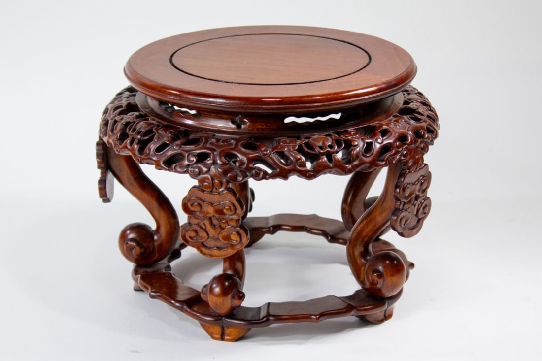 Chinese Carved Hardwood Openwork Pieced Stand: Chinese carved hardwood stand with red-brown finished. Intricately carved with stylized dragons chasing pearls executed in pierced openwork, with cloud panels directly below. Supported by five legs ea