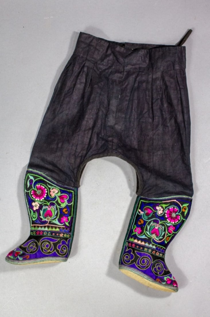 Vintage Chinese Zhuang Child's Pants With Boots: Vintage pair of Chinese Zhuang people's child's boot with attached pants. From Yunnan China, likely mid-century. Vibrant floral embroidery with multicolored and gold threads; applied gilt board rounde