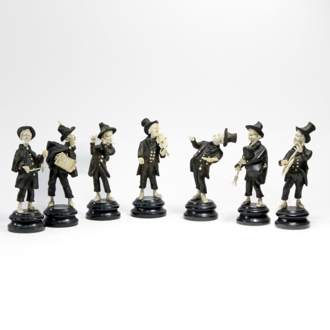 Group of 7 Antique German Carved Wood Musicians: Group of 7 antique German carved wood musicians, 19th century. Group includes conductor, violinist, accordionist, flutist, bagpipe player, mandolin player, and triangle player. Well carved, dark wood 
