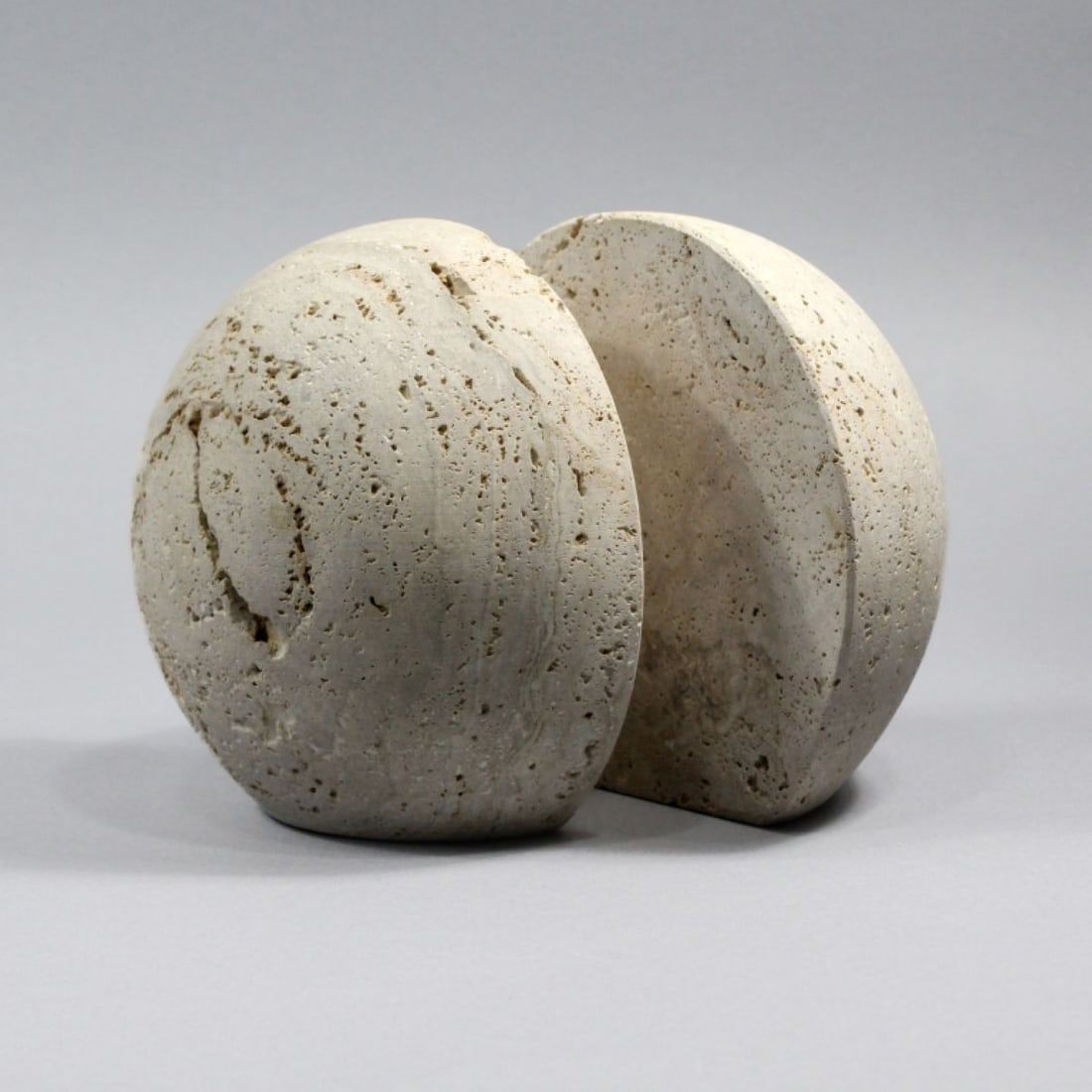 Italian Travertine Half Orb Bookends, circa 1970's: Italian Travertine Half Orb Bookends, circa 1970's. Unmarked with partial labels on base. Each measure 6.5x7" and are 3.5" deep. Very good condition.