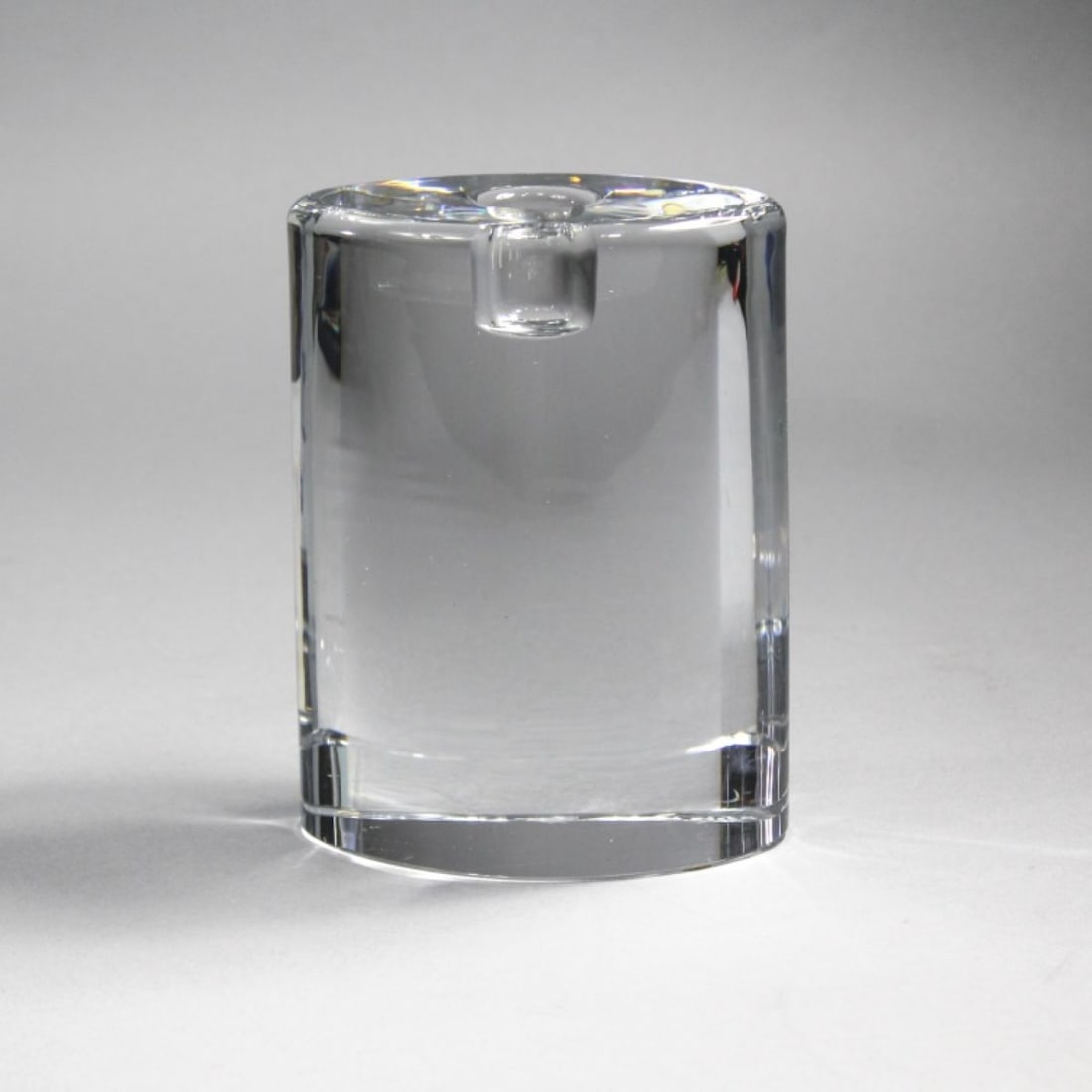 Goran Warff Candle Holder for Kosta Boda: Oval form solid glass block candle holder designed by Goran Warff. Hand etched "Kosta 68005 Warff" to bottom. Very good condition. 5.75" H x 4.25" x 3".