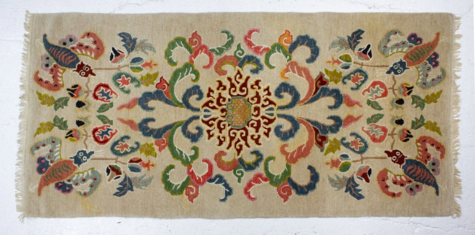 Chinese-Tibetan Bats & Lotus Wool Rug: Chinese-Tibetan wool rug. Woven bats carry pomegranates and Buddha's hand fruits in their mouths, surrounding central lotus, with emanating trailing vines. Thick wool pile on cotton base. In good cond