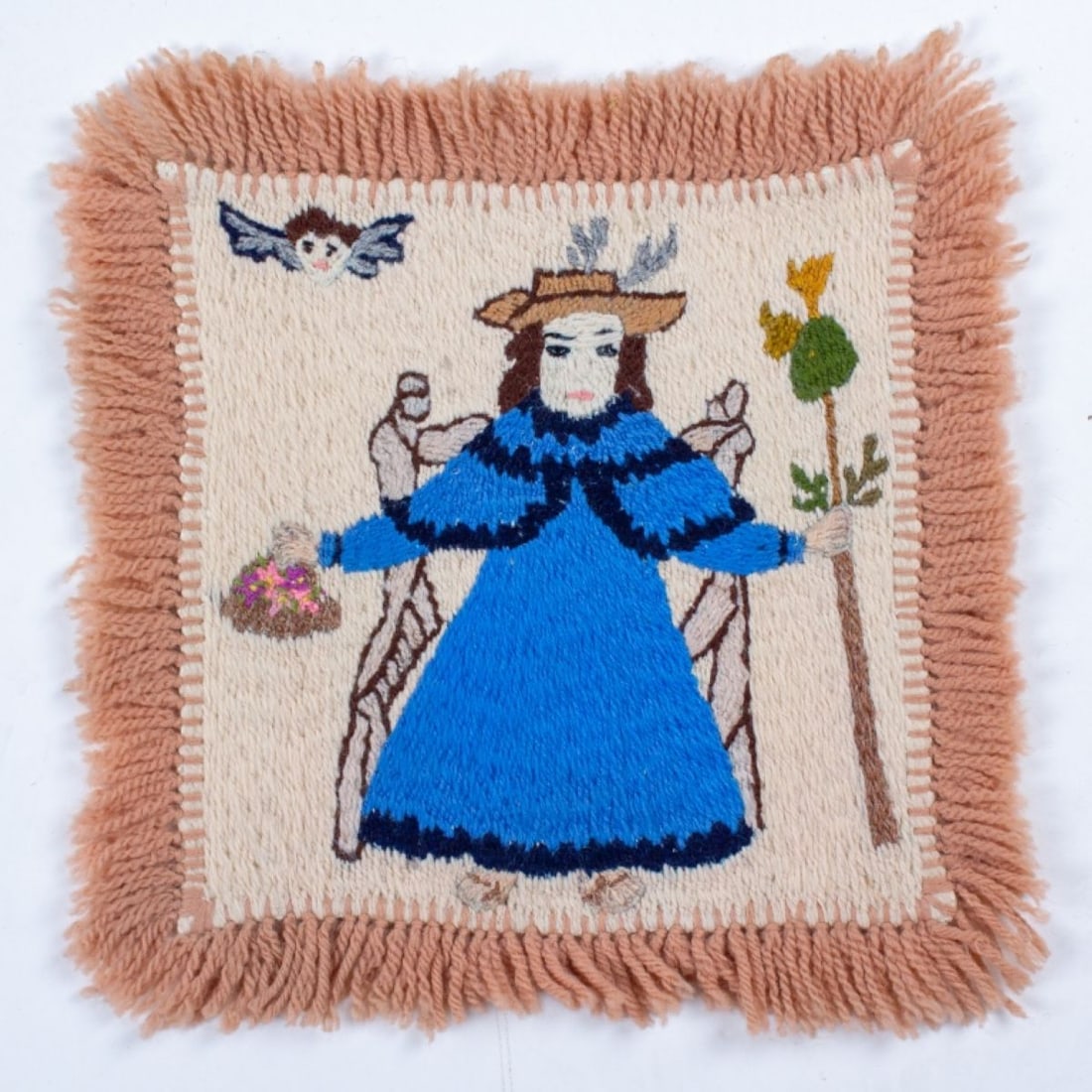 Frances Graves (NM) Colcha Embroidery: Francis Varos Graves (b. 1910). Colcha embroidery with center blue robed figure holding flower basket and staff; winged angel head upper left. Desurmont-Ellis Gallery, Taos N.M., label to the reverse.