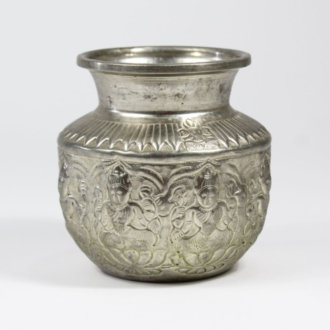 Indian Metal Lakshmi Kalash / Kalasha Pot: Indian Metal Lakshmi Kalash/Kalasha Pot. Traditionally used to carry holy water/plants in Hindu traditions. Hammered white metal depicting the Goddess Laskhmi on all sidessitting on a lotus petal, wit