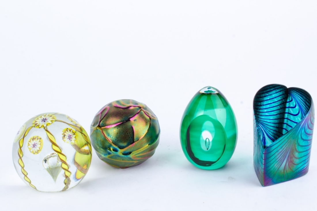 Art Glass Paperweights / Kosta "Ventana" Series: Group of 4 art glass paperweights. (1) Kosta / Mona Morales Schildt "Ventana" series paperweight Signed Kosta to bottom along with 95272. 3.5". (2) Signed The Glass Eye Studio iridescent paperweight.