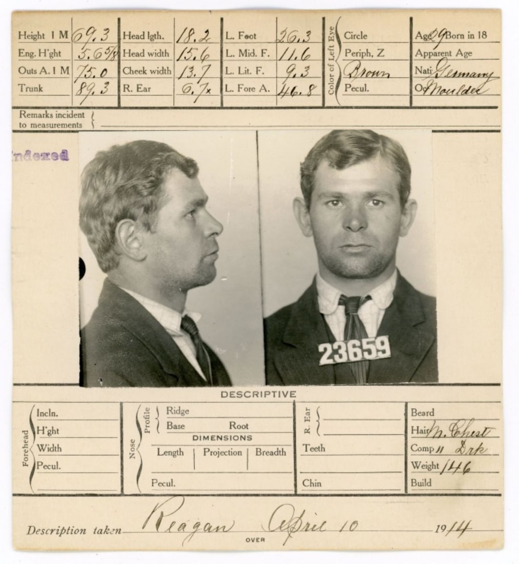 1914 Mushot San Francisco / Robbery Suspect: 1914 mugshot of Otto Schmacker arrested for robbery. Photograph mounted to card with handwritten notations to the front and reverse; includes list of tattoos. Clear sharp image; very good condition. P