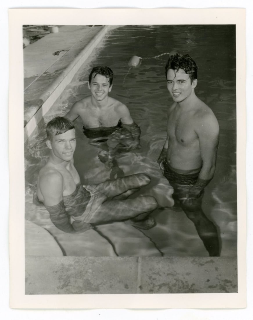 Bob Mizer AMG Nude Male Photos / Dave Wiler: Vintage original AMG photograph of three models in the pool of Bob Mizer's compound; from the estate of the dark haired model pictured right. Pencil written 0 to the back along with NOV 56 date. Good