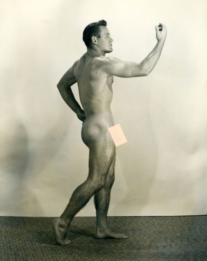 Vintage Dave Martin Male Nude / Pete Lee: Original circa 1950s Dave Martin silver gelatin photograph of Pete Lee posed nude standing with arm up (pose 16 from catalog No. 4). Double-weight fiber low lustre paper. Pen written "Pete Lee-#16" to