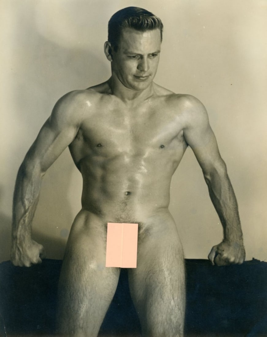 Vintage Dave Martin Male Nude / Pete Lee: Original circa 1950s Dave Martin silver gelatin photograph of Pete Lee posed nude standing with arms on bench (pose 5 from catalog No. 4). Double-weight fiber low lustre paper. Pen written "Pete Lee-#