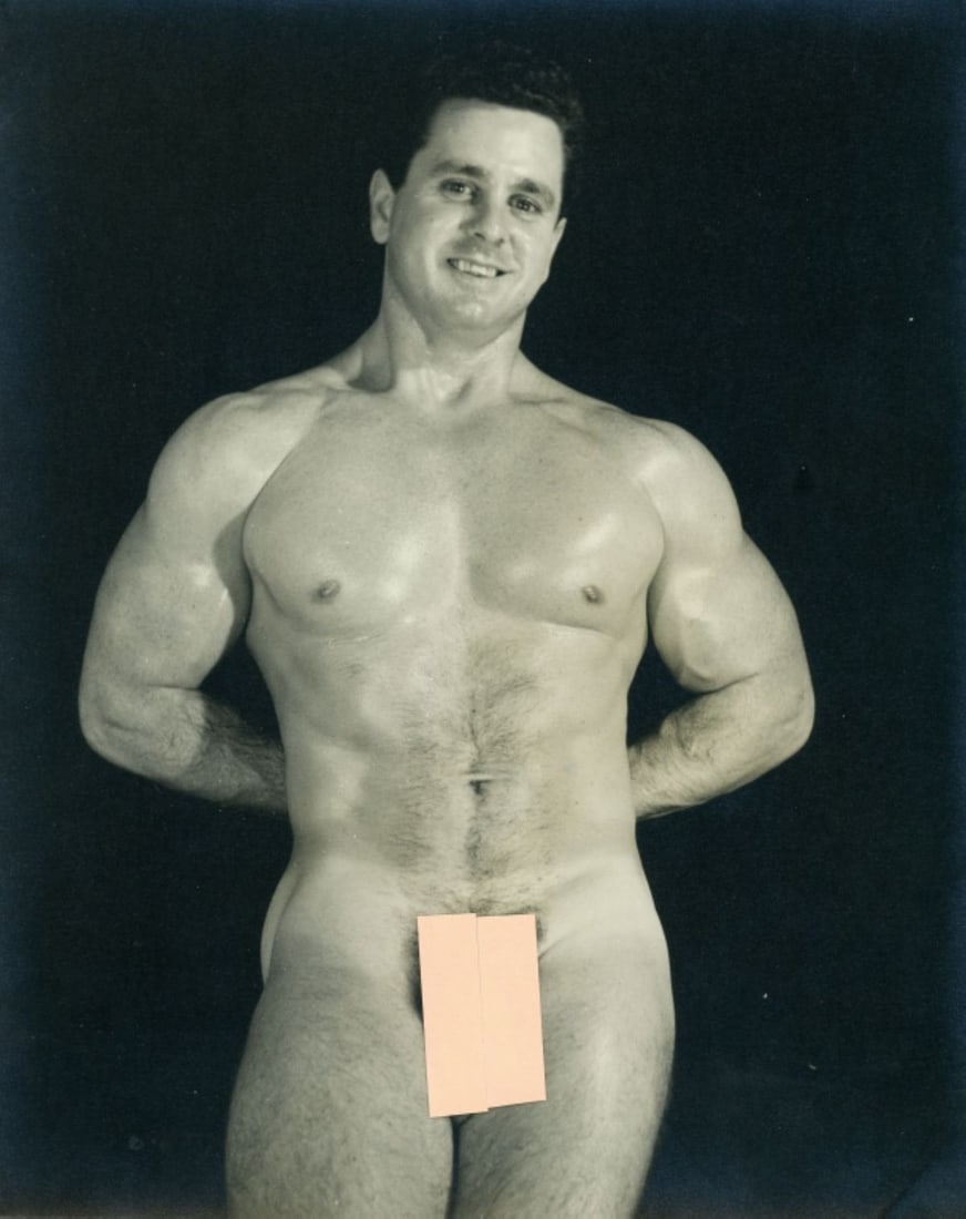 Vintage Dave Martin Male Nude / Brad Payne: Original circa 1953 Dave Martin silver gelatin photograph of Brad Payne posed nude standing with hands behind back (pose 5). Double-weight fiber low luster paper. Pen written "Brad Payne-#15" and "Jul