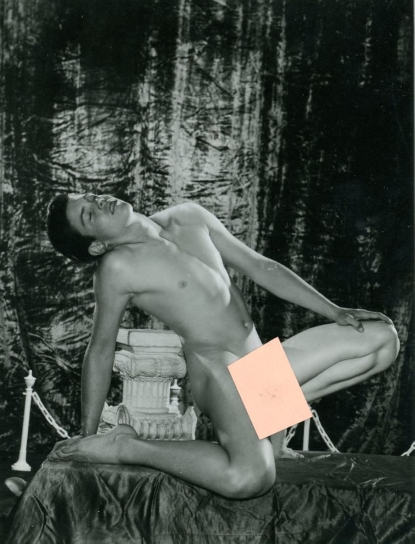 Bob Mizer AMG Male Nude Photo / Butch Umbenhauer: Original Bob Mizer / AMG photograph of model Butch Umbenhauer posed nude in front of a crushed velvet curtain. Clear sharp image on gloss paper. Notations to the back. Good condition; some darkroom de
