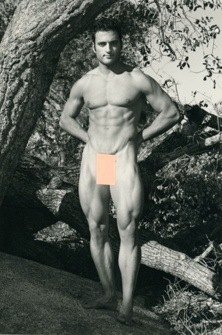Paul Burkhart (CA) Male Nude Art Photograph: Male nude figure posed outdoors with arms behind back in front of tree. Pen signature and Burkhart studio stamp to the reverse. Clear sharp image on slightly textured doubleweight satin paper. Excelle