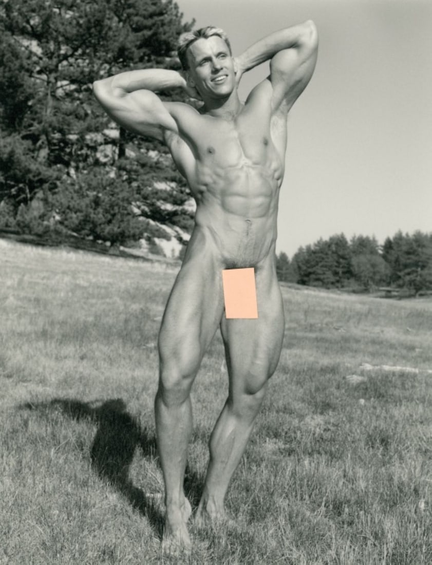 Paul Burkhart (CA) Male Nude Art Photograph: Male nude figure posed standing in field with arms behind head. Pen signature and Burkhart studio stamp to the reverse. Clear sharp image on slightly textured doubleweight satin paper. Excellent condi