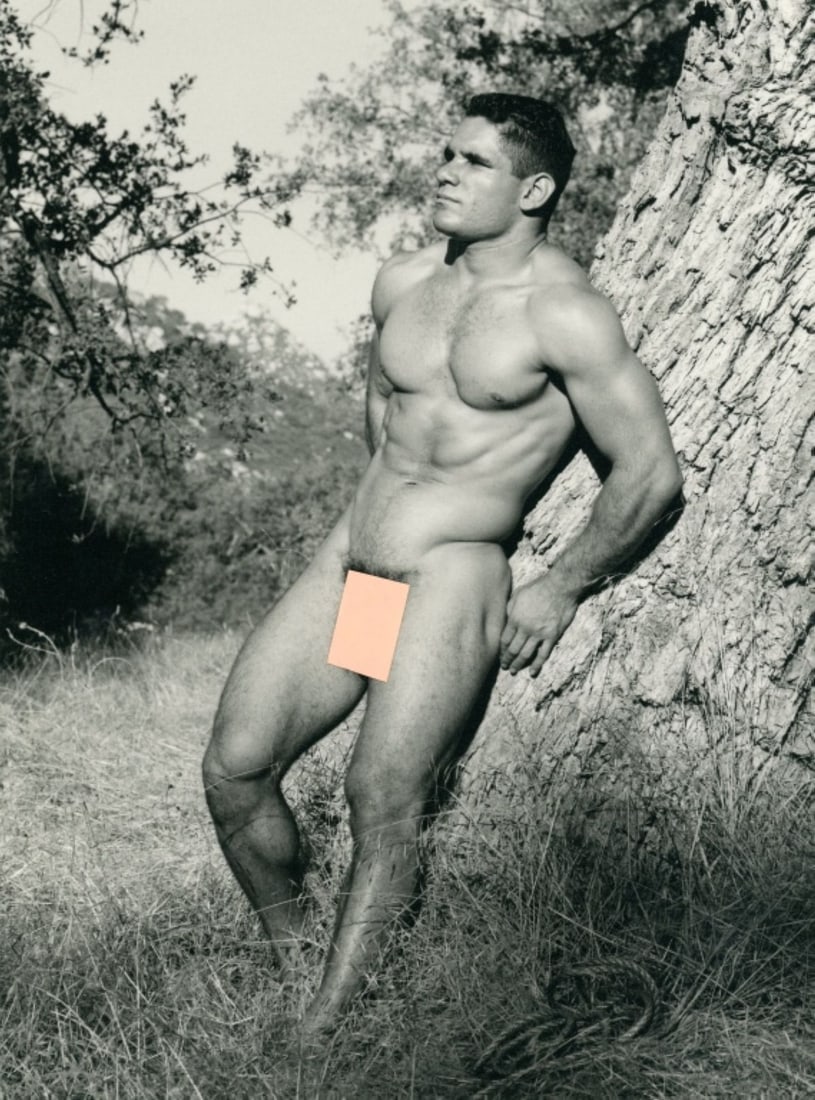 Paul Burkhart (CA) Male Nude Art Photograph: Male nude figure posed outdoors leaning against large tree. Pen signature and Burkhart studio stamp to the reverse. Clear sharp image on slightly textured doubleweight satin paper. Excellent condition