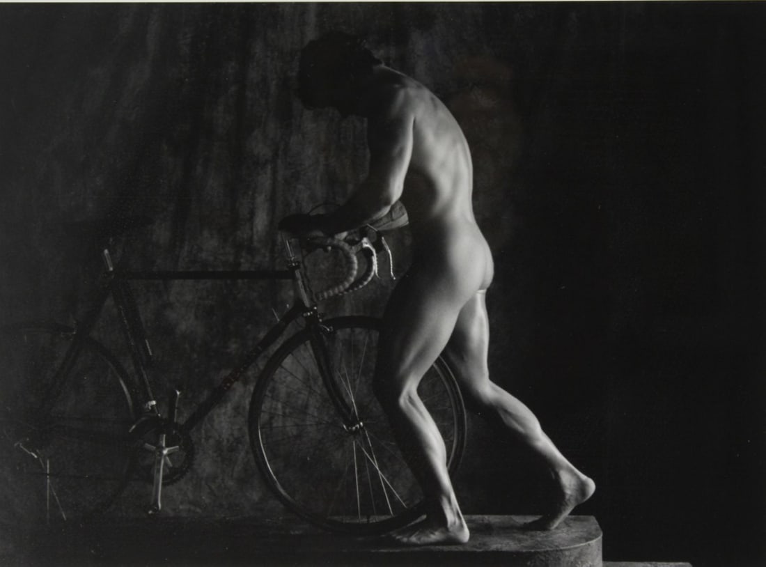 Male Nude Photograph Signed Fenton: Silver gelatin photograph of nude man posed with bicycle. Numbered 1/ 25 and signed Fenton in silver ink to lower margin. Clear sharp image on satin paper. Metal frame. Mat opening 10.5" x 13.5". Fram